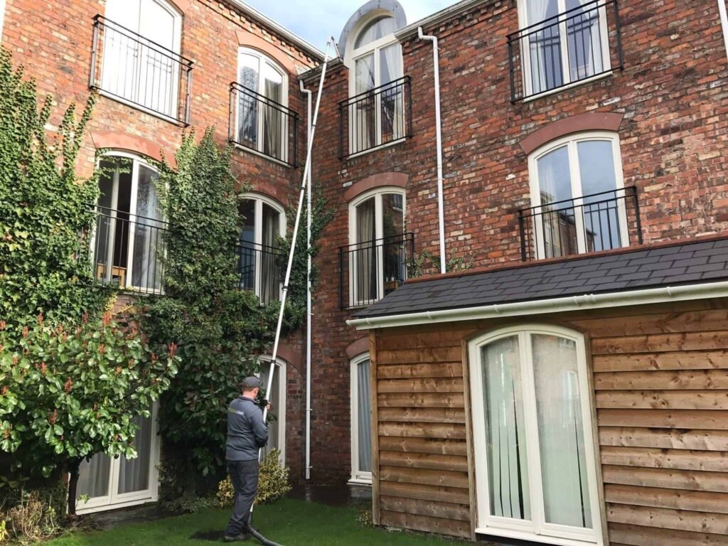 Gutter Cleaning at Apartment Complex in Cheshire carried out safely from the ground.