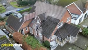 Pristine Clean England team using a scaffold tower for safe roof moss removal in Northwich.