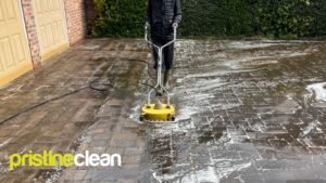 Professional rotary surface pressure washing cleaning a block paved driveway in Cheshire