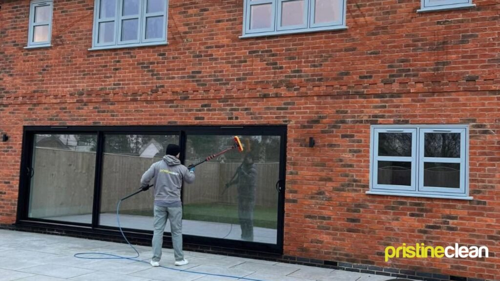 A professional window cleaner in cheshire using the reach and wash pure water brush technique that fixes streaky window problems
