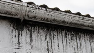 Black streaks on UPVC fascia boards caused by dirty gutter overflow on a Northwich property